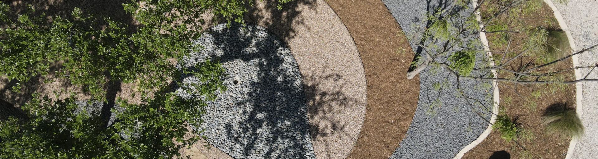 Wemberly xeriscape front yard with native plantings, decomposed granite paths, and limestone accents